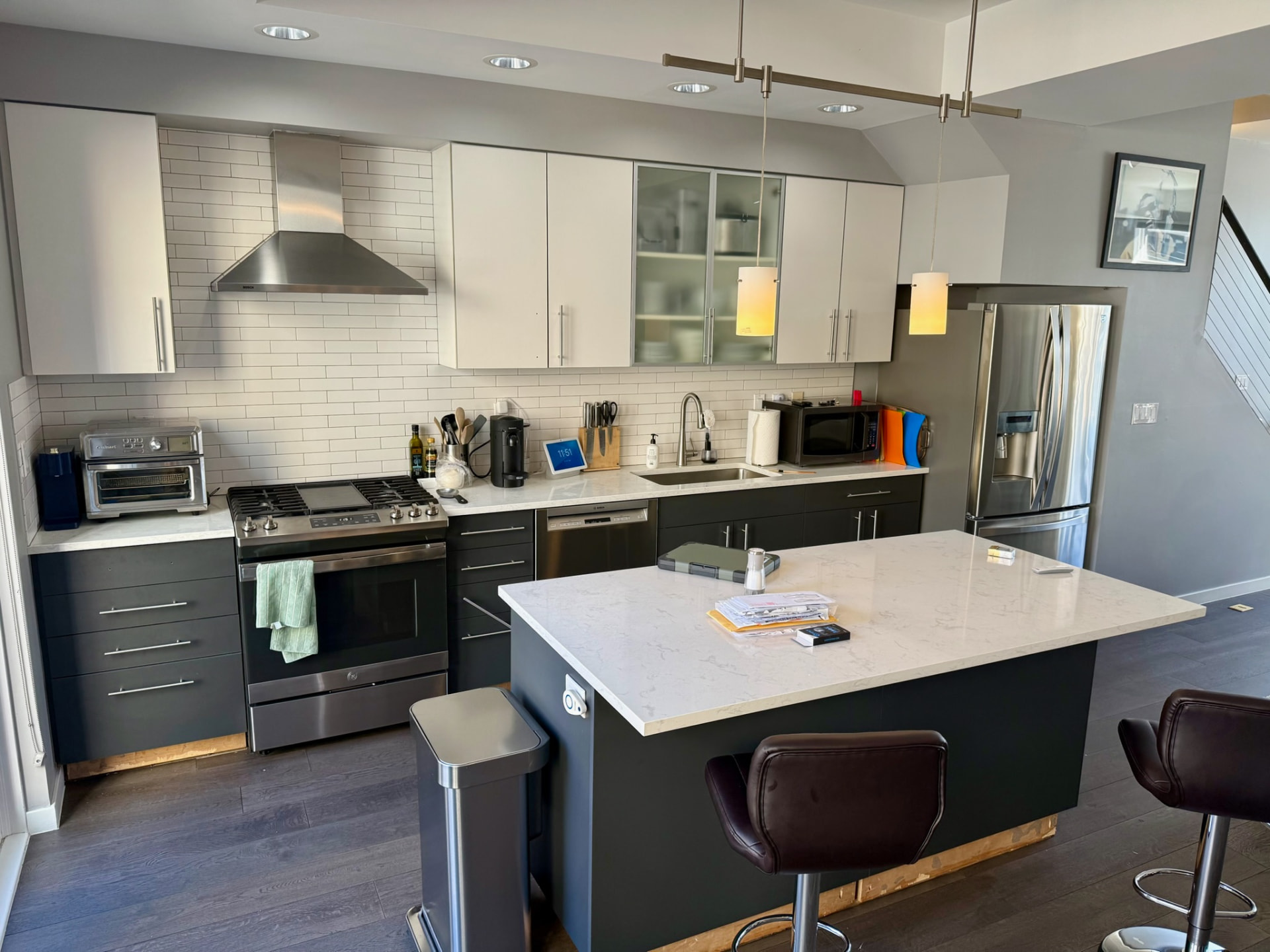 Original kitchen with stainless hood and white upper cabinets